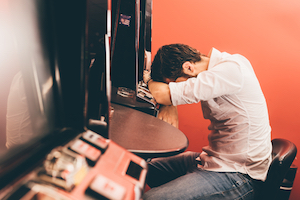 Problem Gambling, Problem Gambler sitting at FOBT machine